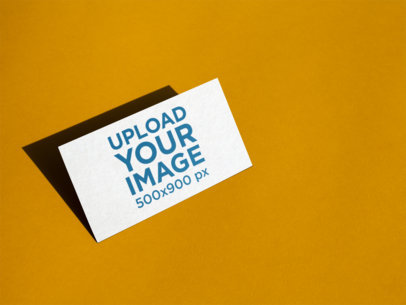 Business Card Mockup Standing Angled on a Yellow Surface