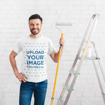 T-Shirt Mockup Featuring a Man Painting a Wall 