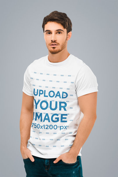 T-Shirt Mockup of a Serious Man Casually Posing in a Studio