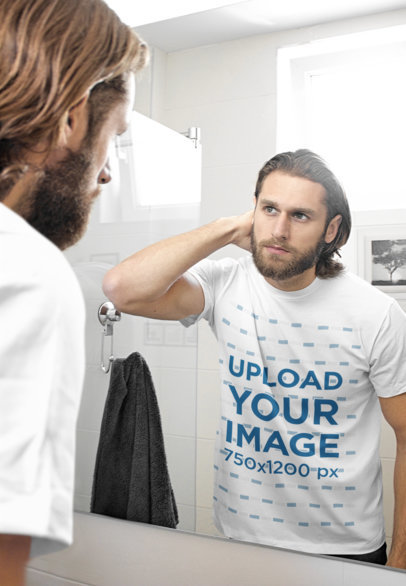 T-Shirt Mockup of a Bearded Man Looking at Himself in a Mirror 