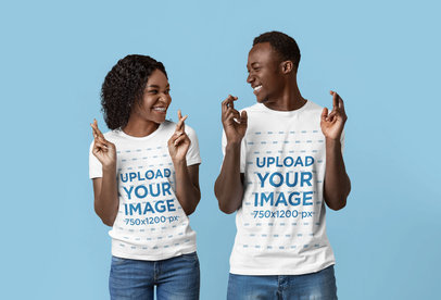 T-Shirt Mockup of a Couple Crossing Fingers in a Studio