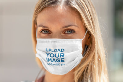 Face Mask Mockup Featuring a Serious Woman Looking to the Camera 