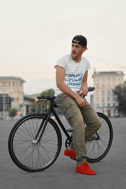 Basic T-Shirt Mockup Featuring a Serious Man Sitting on His Bike 