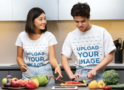 T-Shirt Mockup Featuring a Young Couple Cooking Healthy Food 