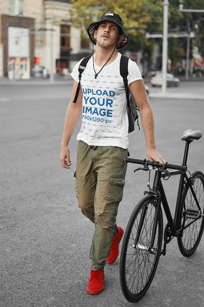 T-Shirt Mockup Featuring a Man Walking with His Bicycle