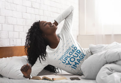 Mockup of a Woman Reading in Bed in a Heather Long Sleeve Tee