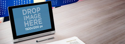Mockup of a Yoga Silver Tablet in Landscape Position by a Pen