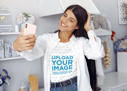 T-Shirt Mockup of a Young Woman Taking a Selfie at Home