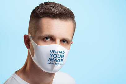 Face Mask Mockup Featuring a Serious Man in a Studio