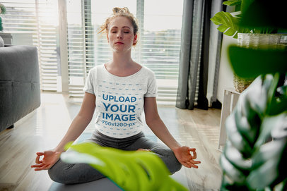 T-Shirt Mockup of a Woman Meditating in Her Apartment