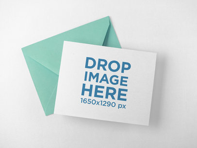Invitation Card with Envelope Lying Above a Solid Surface