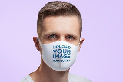 Mockup of a Serious Man Wearing a Face Mask in a Studio
