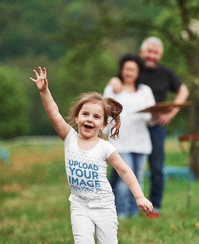 T-Shirt Mockup Featuring a Joyful Little Girl