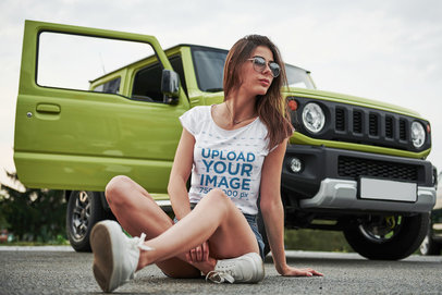 T-Shirt Mockup of a Serious Woman Sitting on the Floor Next to an Off-Road Vehicle 