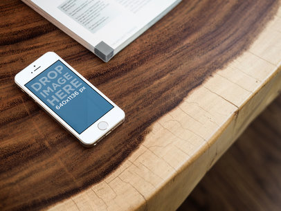 iPhone Mockup Featuring a Wooden Table