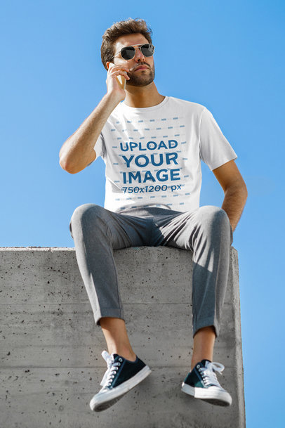 Basic T-Shirt Mockup of a Serious Man Making a Call 