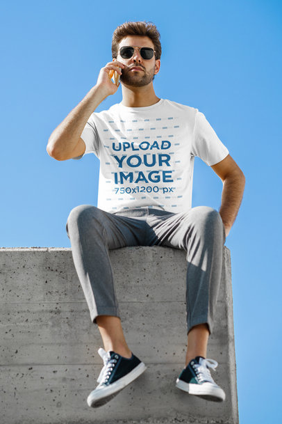 T-Shirt Mockup of a Man Sitting on the Edge of a Roof
