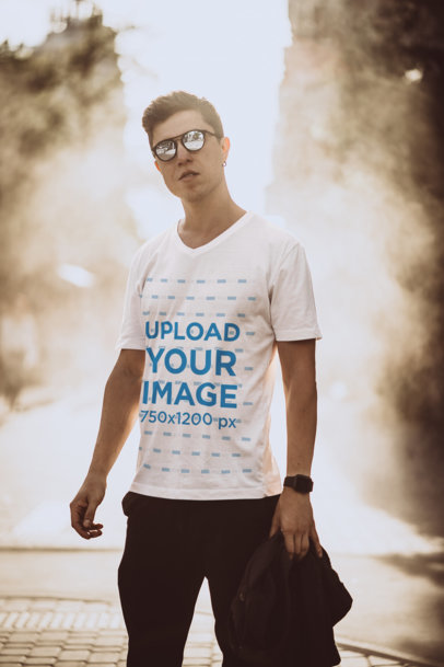 Mockup of a Man Wearing a V-Neck T-Shirt Posing in the City 