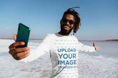 Long Sleeve Tee Mockup of a Happy Man Taking a Selfie at a Salt Flat