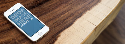 Mockup of an iPhone 5S Placed on a Wooden Table