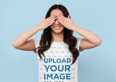 T-Shirt Mockup of a Woman Covering Her Eyes in a Studio