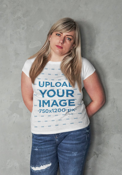 T-Shirt Mockup of a Woman Leaning over a Concrete Wall 