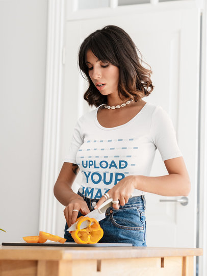 T-Shirt Mockup Featuring a Woman Cutting Vegetables