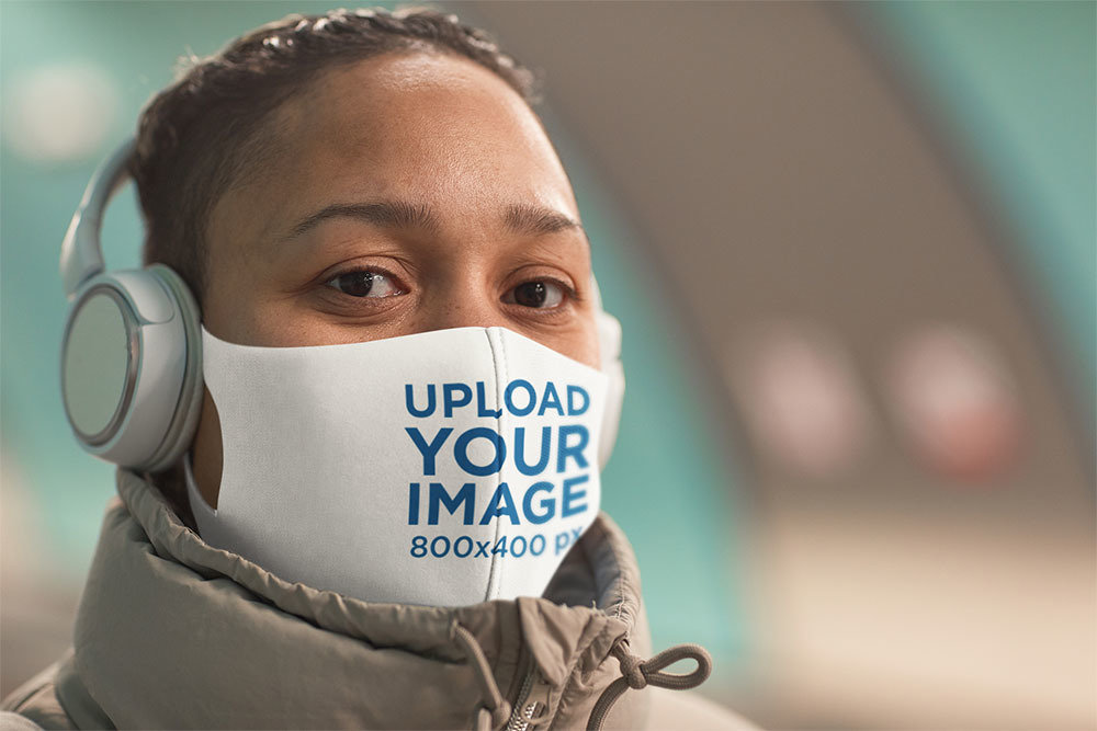 Mockup of a Woman Wearing a Face Mask While Listening to Music