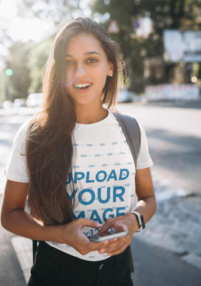 T-Shirt Mockup Featuring a College Student on a Sunny Day