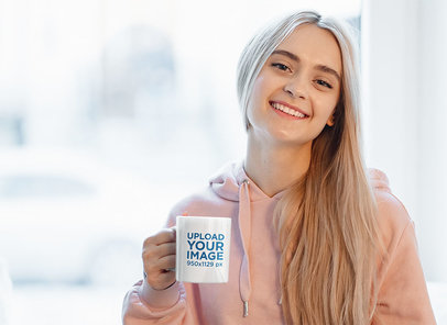 Mockup of a Blonde Woman Holding an 11 oz Mug