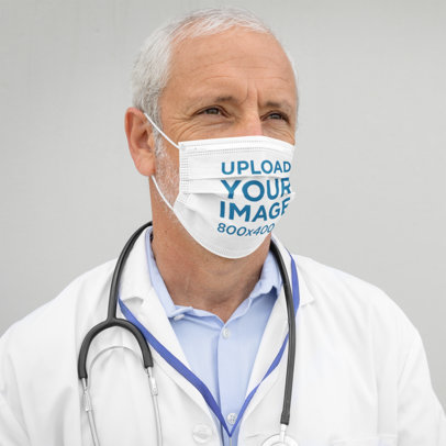 Face Mask Mockup of a Serious Doctor Against a Plain Backdrop