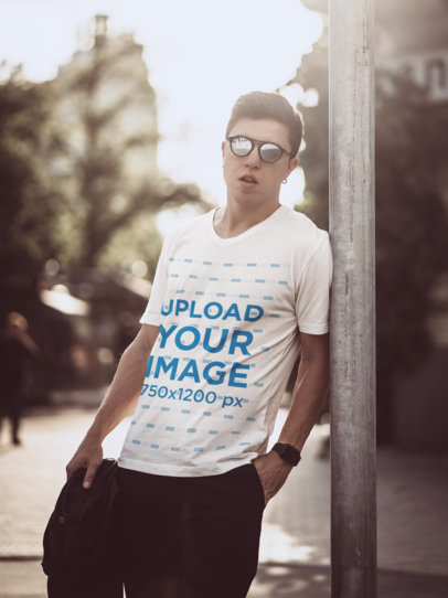 V-Neck T-Shirt Mockup Featuring a Man With Sunglasses Posing in the City 