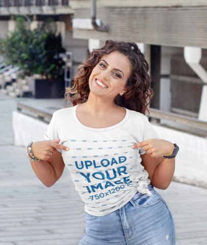Mockup of a Happy Woman Pointing at Her Knotted T-Shirt 