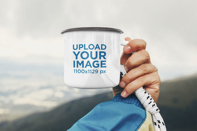 Mockup Featuring a Hand Holding an Enamel Mug Against a Natural Landscape 46885-r-el2