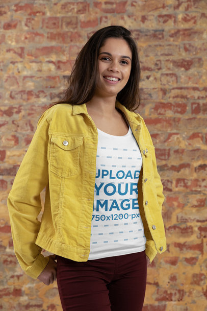 T-Shirt Mockup of a Happy Woman Posing Against a Brick Wall