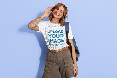 Crew-Neck T-Shirt Mockup Featuring a Tattooed Woman Listening to Music 