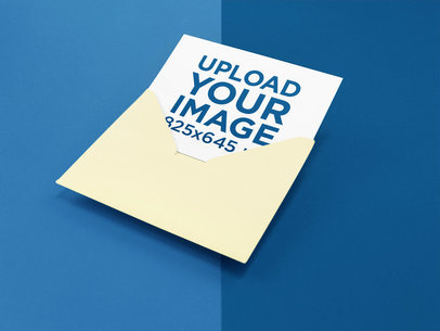 Invitation Coming out of an Envelope Mockup on a Two Colors Surface