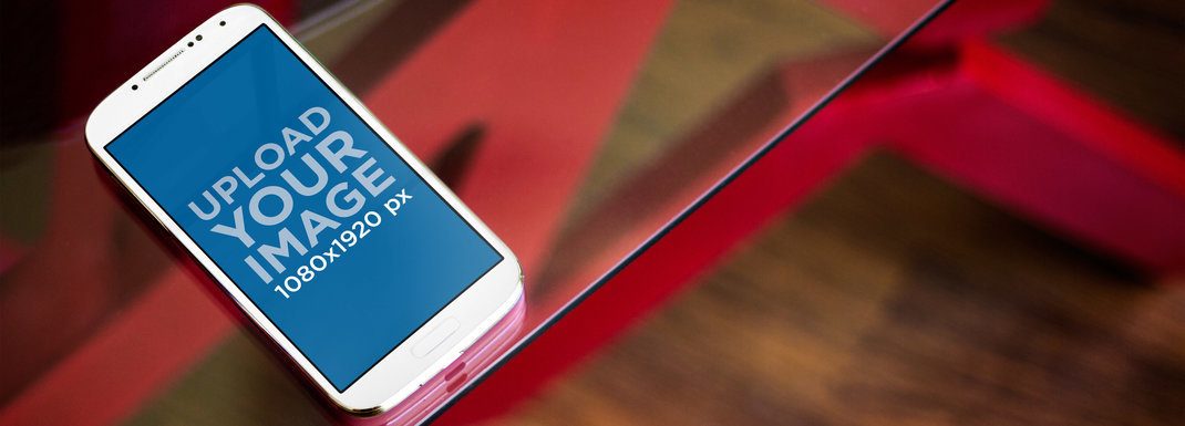 Mockup of a Samsung Galaxy in Portrait Position on a Glass Table