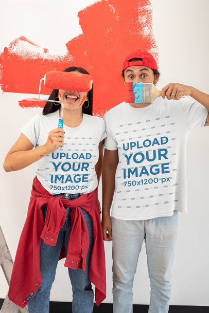 T-Shirt Mockup Featuring a Joyful Couple Painting a Wall