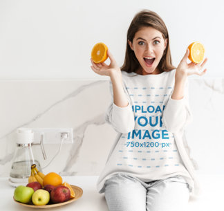 Sweatshirt Mockup of a Surprised Woman Holding a Sliced Orange 