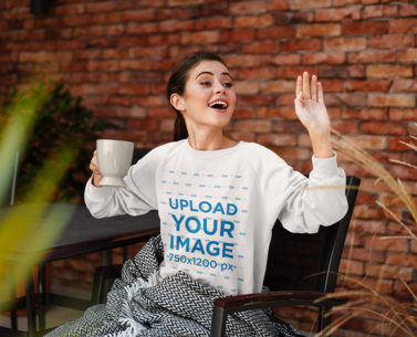 Sweatshirt Mockup of a Happy Woman Waving at Someone 