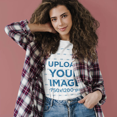 Basic T-Shirt Mockup of a Curly-Haired Woman Posing Against a Colored Backdrop 