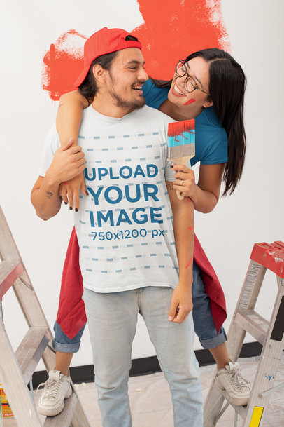 T-Shirt Mockup Featuring a Man Having Fun Painting with His Girlfriend 