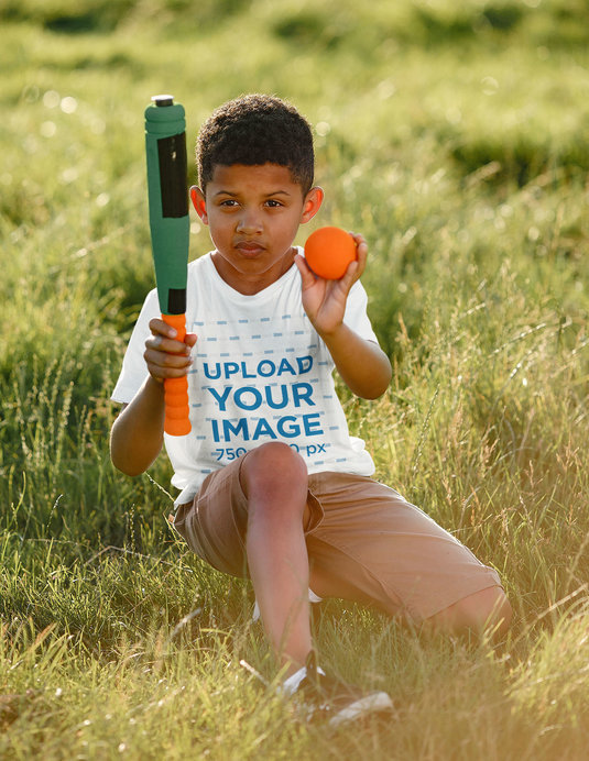 T-Shirt Mockup of a Serious Kid Holding a Toy Baseball Bat 