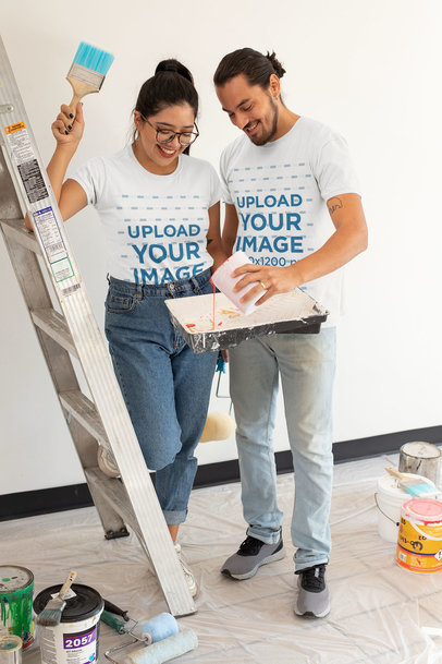 T-Shirt Mockup of a Happy Young Couple Painting Their Apartment 