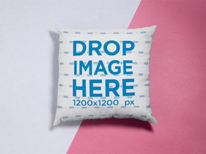 Mockup of a Square Pillow Lying on a Pink and White Surface