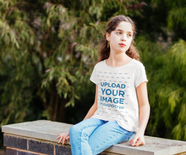 T-Shirt Mockup Featuring a Curly Haired Girl Sitting on a Bench 40903-r-el2