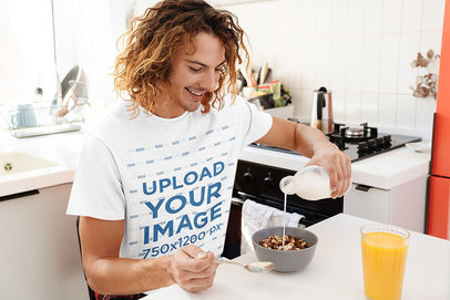 T-Shirt Mockup of a Happy Curly-Haired Man Having Breakfast 