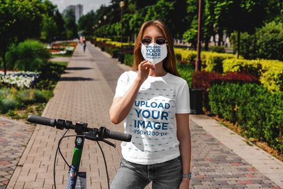 T-Shirt and Face Mask Mockup Featuring a Woman with a Scooter