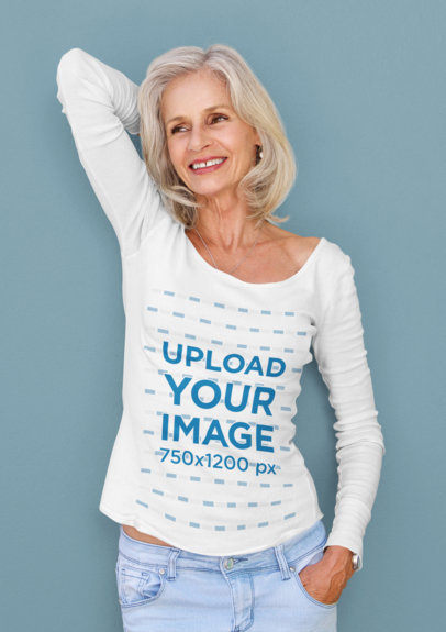 Long-Sleeve Tee Mockup Featuring a Happy Senior Woman Leaning Against a Solid Color Wall